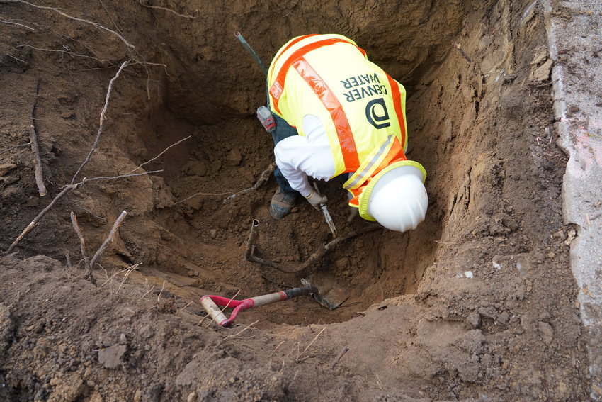 A worker with Denver Water removes a lead pipe from a customer’s plumbing system. The utility organization estimated that there are between 50,000 to 90,000 lead service lines in their system.